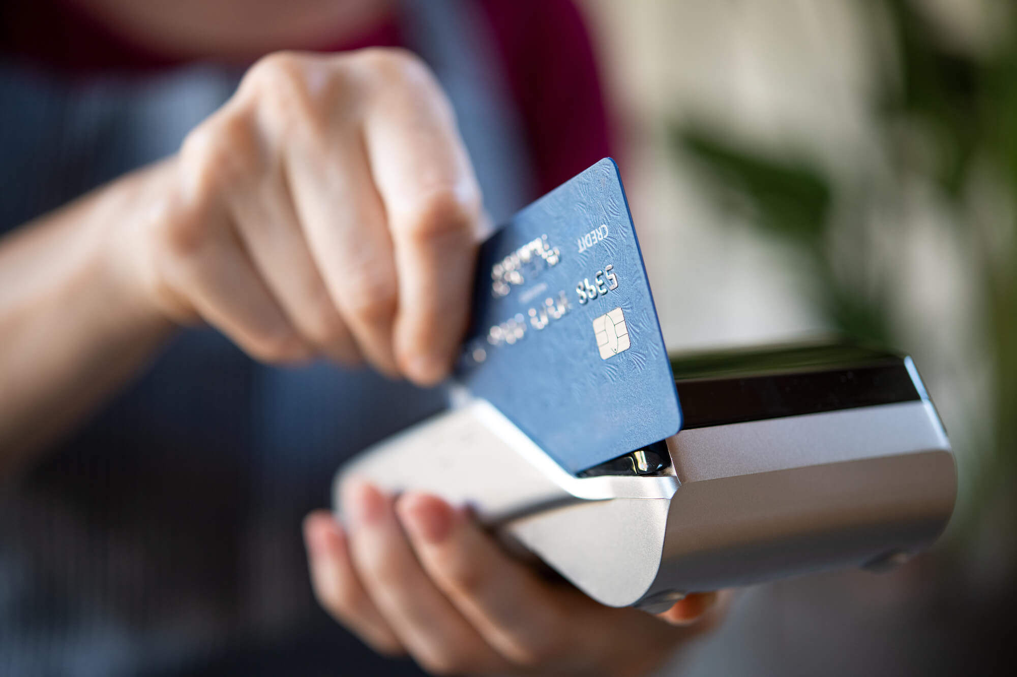 Hotel employee swiping a guest's credit card