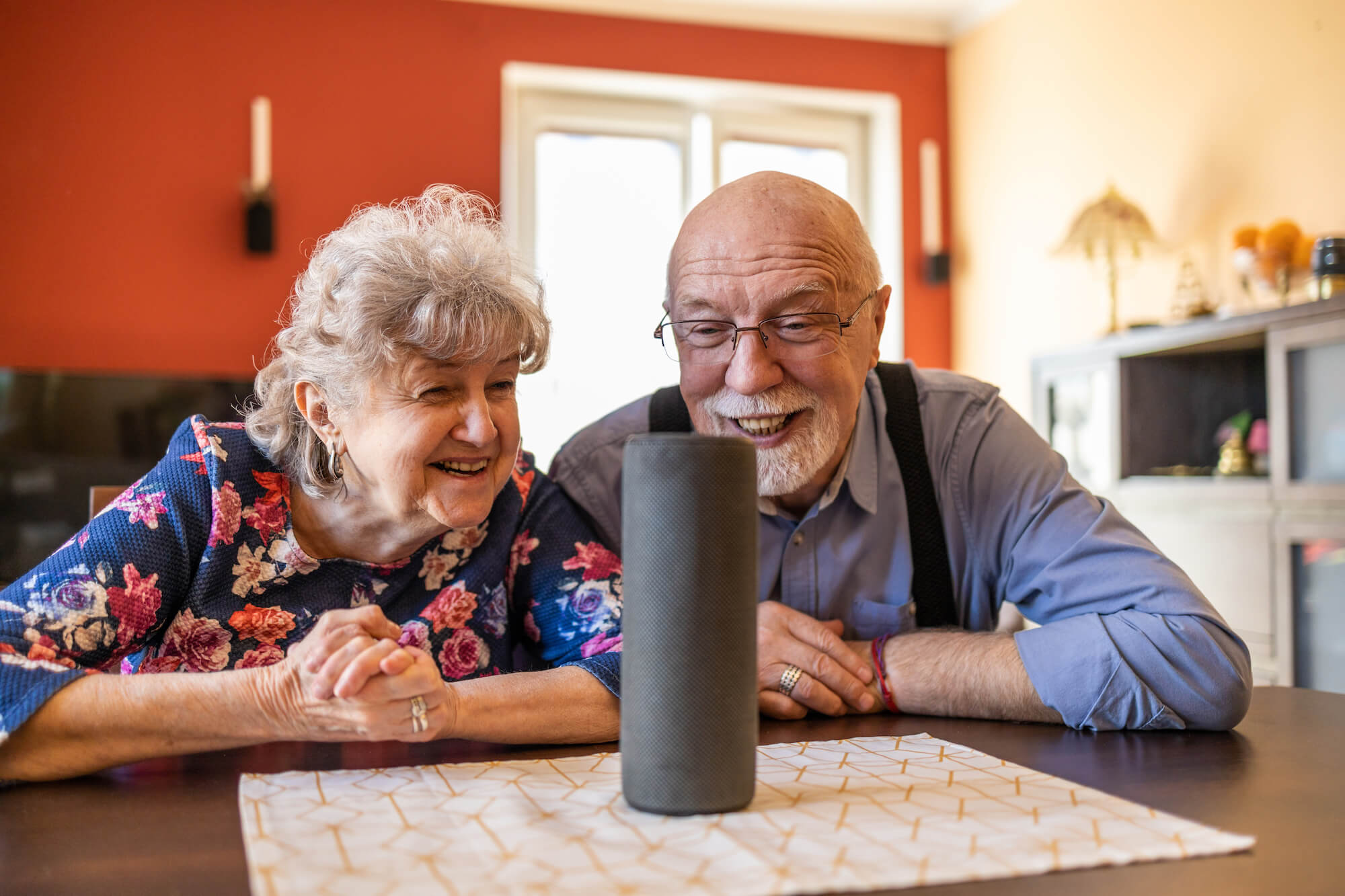 Senior couple using a smart speaker AI personal assistant
