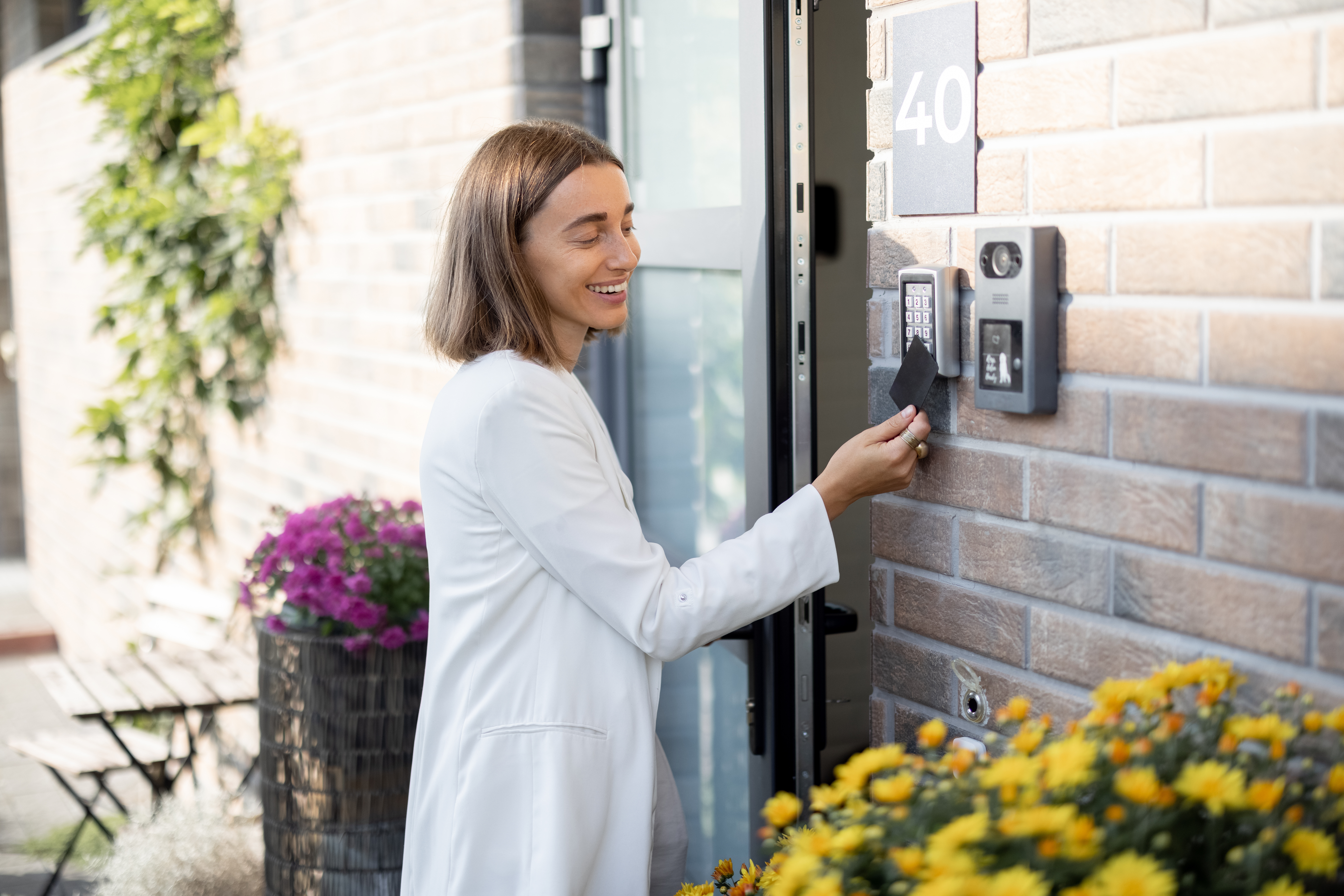 A tenant enters their home by using a keycard on a security electronic lock.